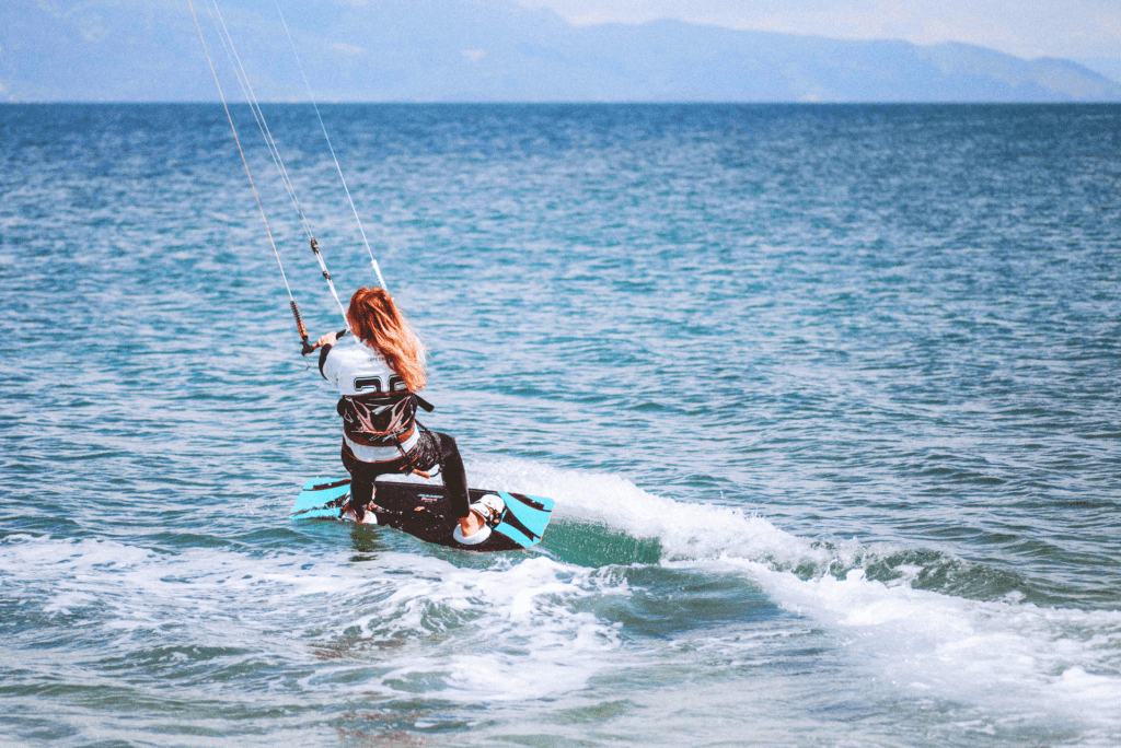 Woman kite surfing in ocean