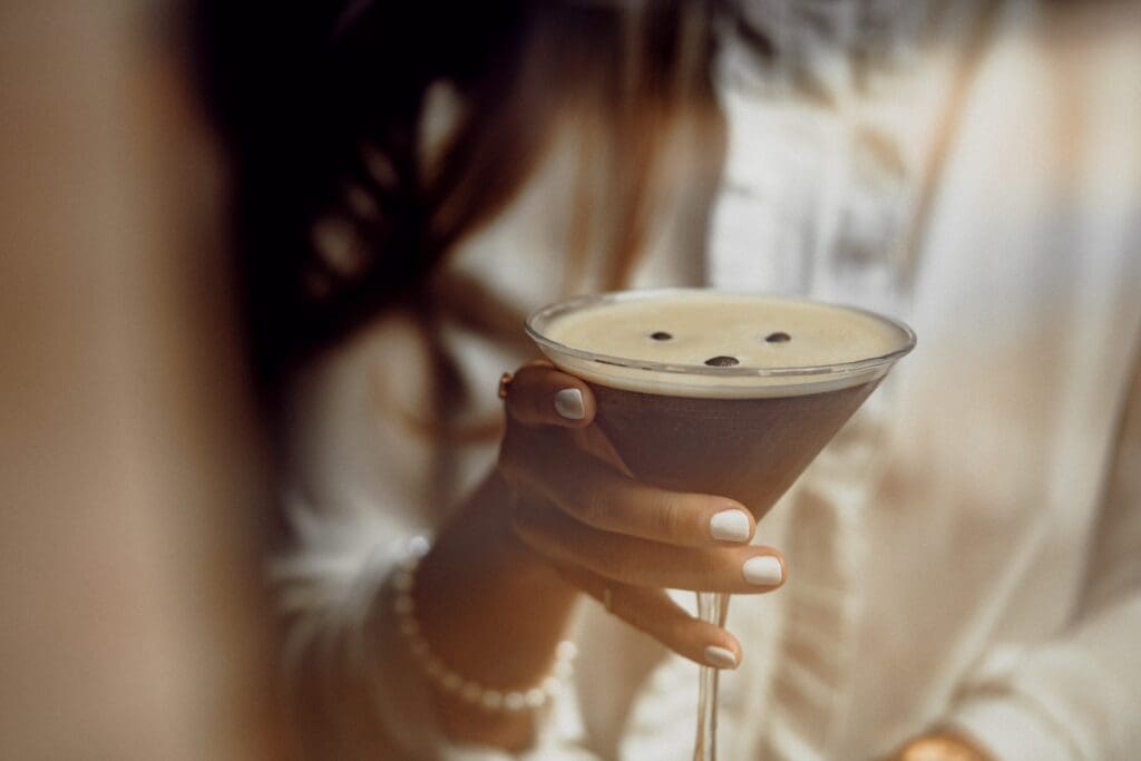 woman's hand holding espresso cocktail