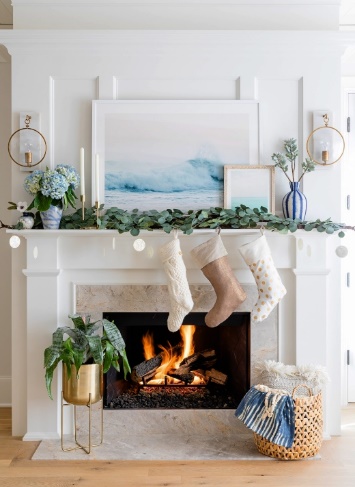 Cozy and welcoming coastal fireplace decorated for the holidays in neutral tones