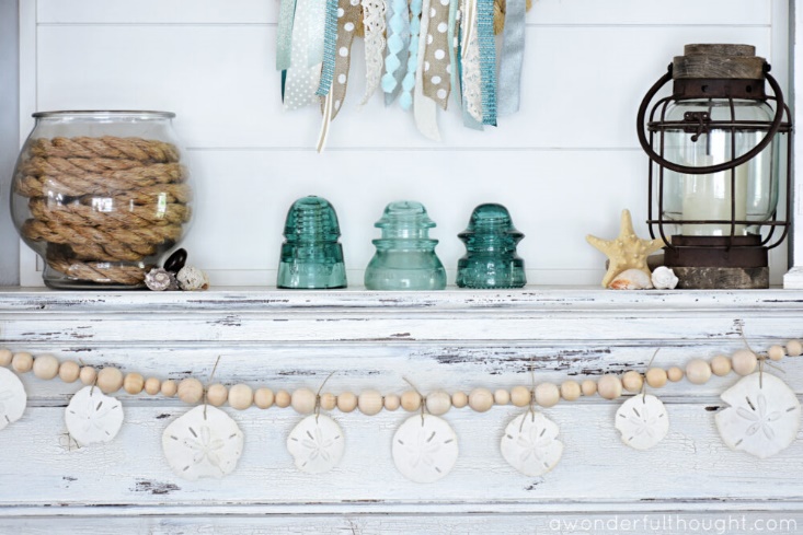 Beautiful DIY garland with wood beads and sand dollars